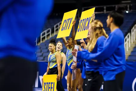 Jah'Liyah Bedminster and Ciara Ward holding "Steel City" signs