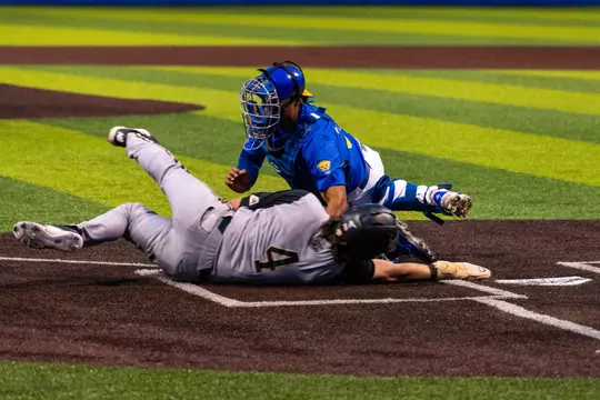 A Pitt catcher and Bryant baserunner collide at home plate