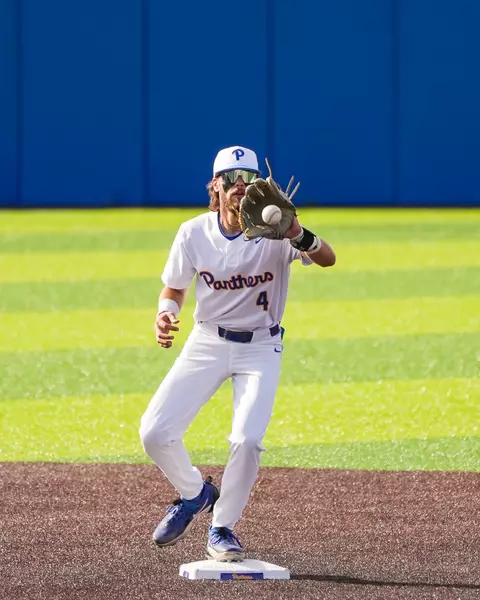 Pitt baseball player fields a ball