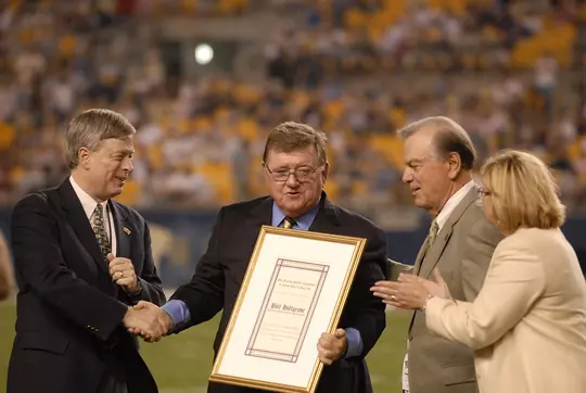 Bill Hillgrove is presented with the NFF Chris Schenkel Award on the field at Heinz field