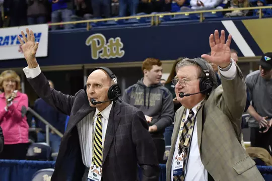 Bill Hillgrove and Dick Groat wave to the crowd at a PItt basketball game