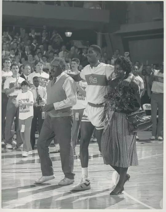CHARLES SMITH being escorted by his parents to center court on senior night