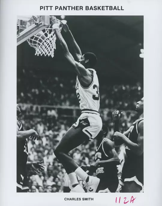 CHARLES SMITH dunking a ball in a pitt uniform