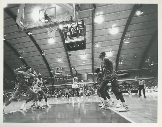 Charles smith gets ready to take a foul shot in a wide angle photo of the Fitzgerald Fieldhouse