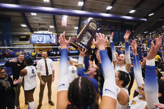 The Pitt volleyball team celebrates with a final four trophy