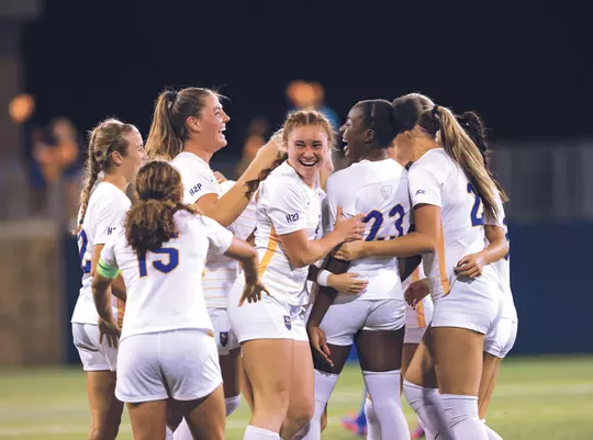 The Pitt Women’s Soccer team celebrates Samiah Phiri and Ellie Coffield after the duo produced the game-winning goal to take down the Duke Blue Devils for the first time in program history