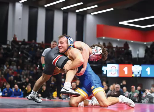 Cole Matthews goes for a takedown during a wrestling match