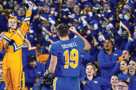 Nate Yarnell raising a fist to a crowd of Pitt students