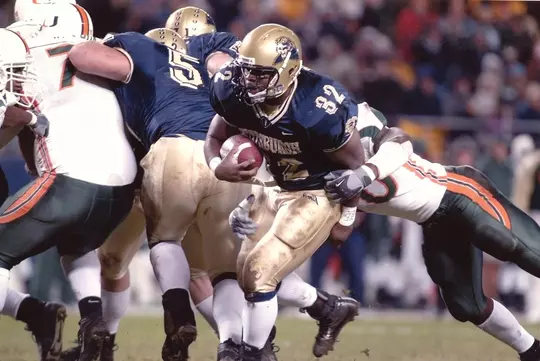 Polite carrying the football in a Pitt uniform
