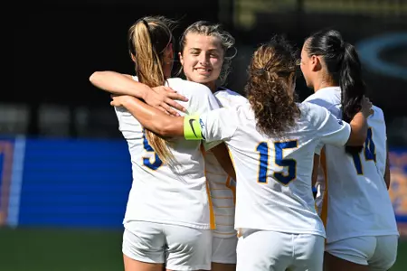 Lola Abraham hugs Chloe Minas, Olivia Lee and Sarah Schupansky in post goal celebration.