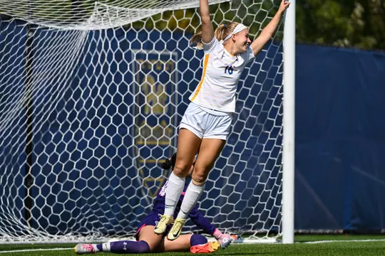 A pitt womens soccer player cheers after scoring a goal