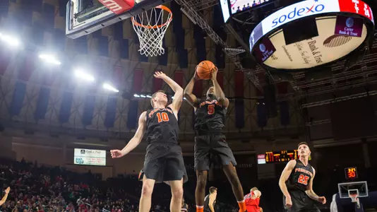 Spencer Weisz (10) and Amir Bell (5) secure a rebound.