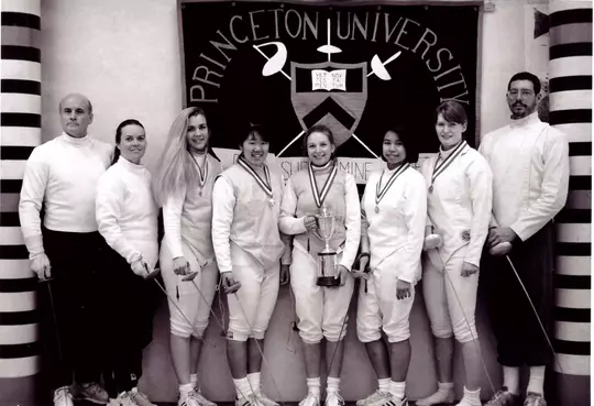women's fencing team with trophy
