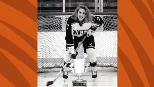 Katherine Issel '95 posed photo with a trophy