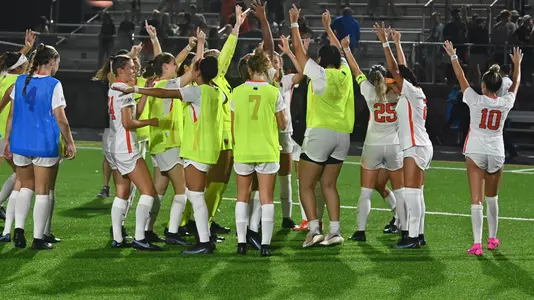 women's soccer team waves to fans