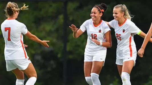 Marissa Hart, Lily Bryant and Tatum Gee celebrate a goal.