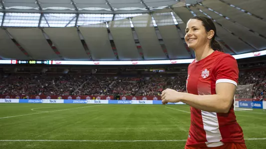 Diana Matheson walks onto the field in Vancouver, Canada.