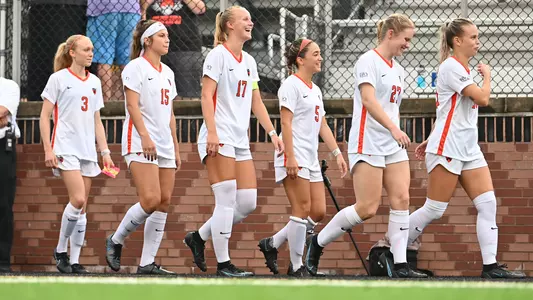 Princeton women's soccer players walk toward the bench.