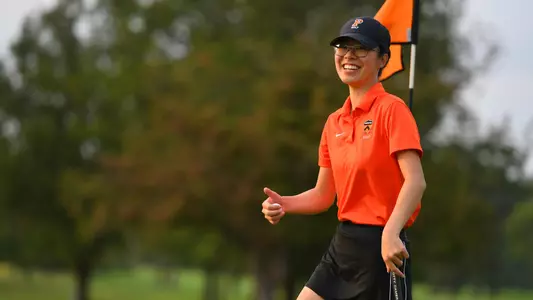 Tiffany Kong smiles on the golf course