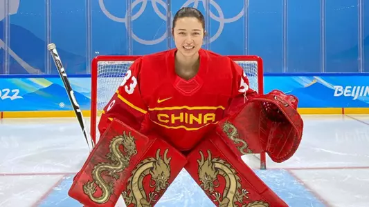 Kim Newell poses in front of net at beijing olympics