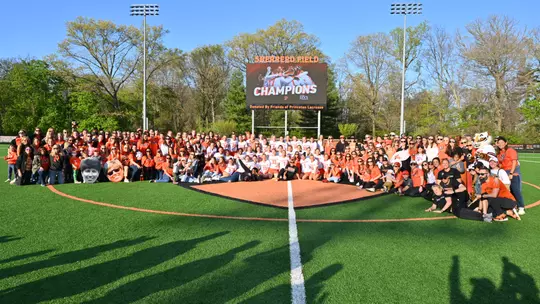 The Princeton women's lacrosse alumni and team gather with Chris Sailer