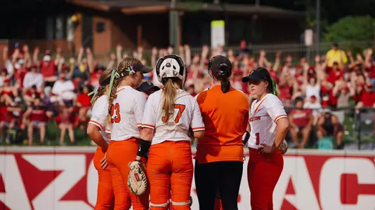 Princeton softball huddle vs. Arkansas