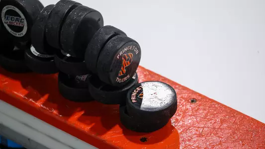 pucks on top of hockey board