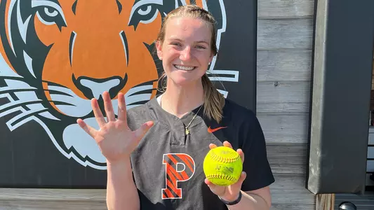 Alexis Laudenslager holding no-hitter ball with hand splayed signifying five career no-hitters