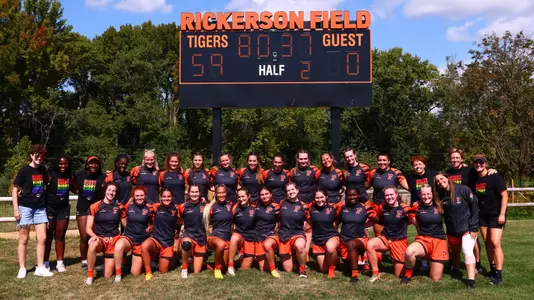 Rugby team in front of scoreboard