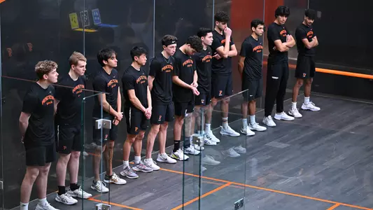 men's squash players stand during introductions