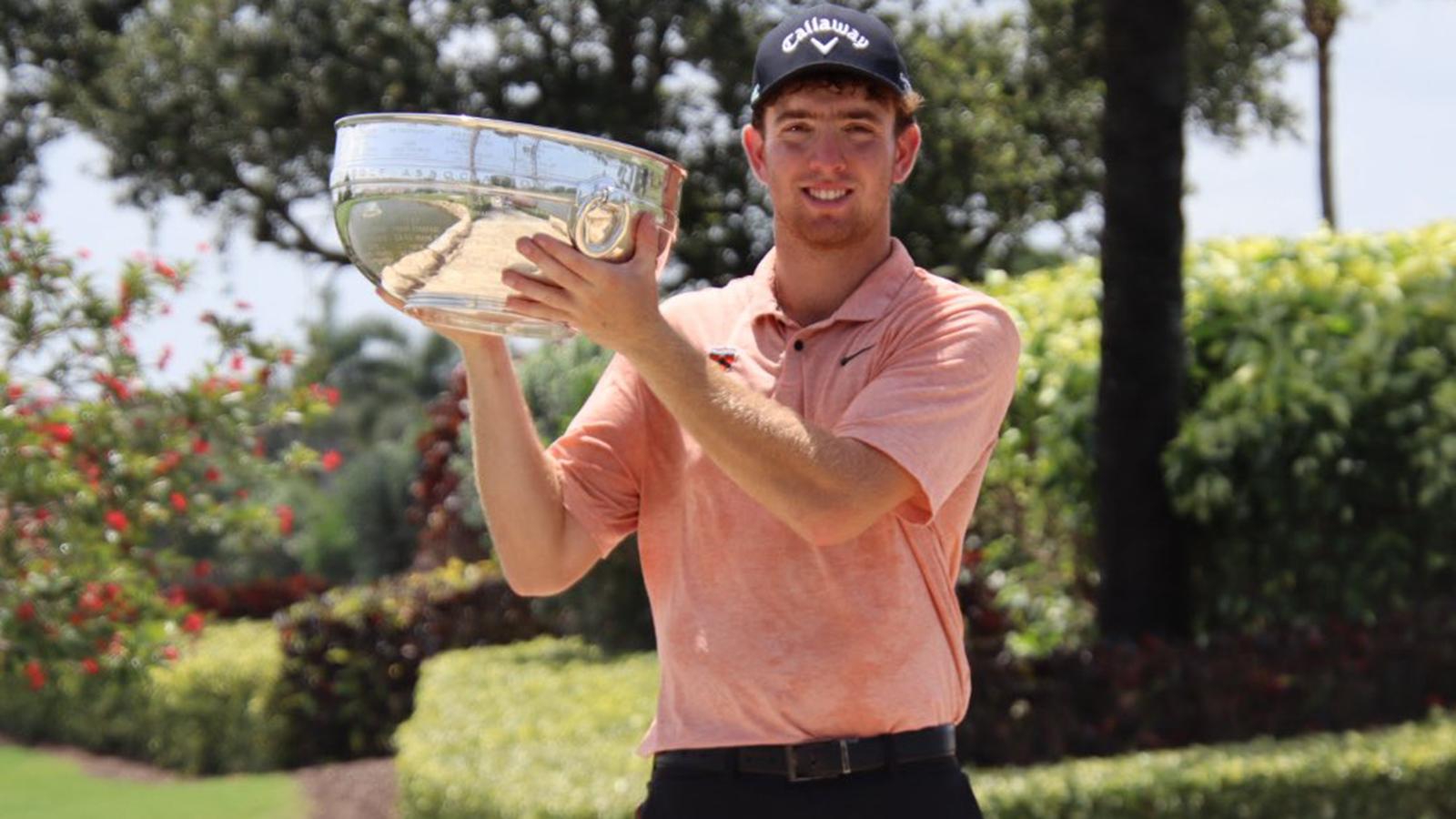 Reed Greyserman hoists the Florida State Amateur trophy at BallenIsles Country Club.
