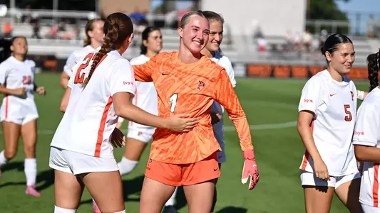 cecilia cerone smiling with teammates on field