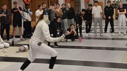 fencing action with fencer reaction behind