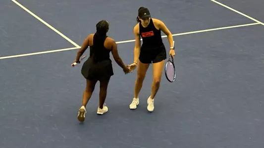 Tsehay Driscoll and Pearlie Zhang clap hands