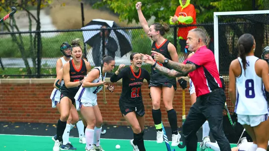 Ella Cashman celebrates her game-winning goal in overtime against No. 1 Northwestern along with her teammtes. Cashman's has her arm raised over her head in victory.
