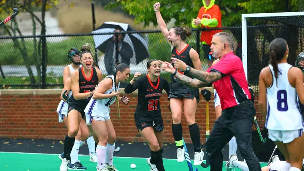 Ella Cashman celebrates her game-winning goal in overtime against No. 1 Northwestern along with her teammtes. Cashman's has her arm raised over her head in victory.