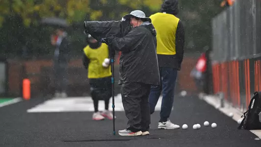 Photographer Shelley Szwast takes pictures in the rain during Princeton's 2-1 win over Northwestern in field hockey Sunday, Oct. 11, 2026