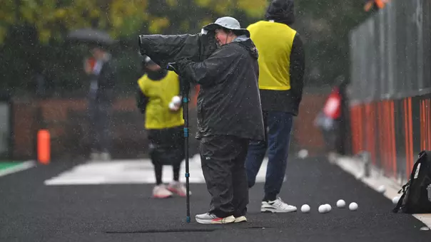 Photographer Shelley Szwast takes pictures in the rain during Princeton's 2-1 win over Northwestern in field hockey Sunday, Oct. 11, 2026