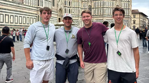 Owen Fischer, Matt Madalon, Drew Cottrell and Wilder Burgin stand in front of a cathedral in Florence, Italy