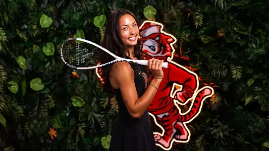 Alex Jaffe posed smiling with racquet over shoulder