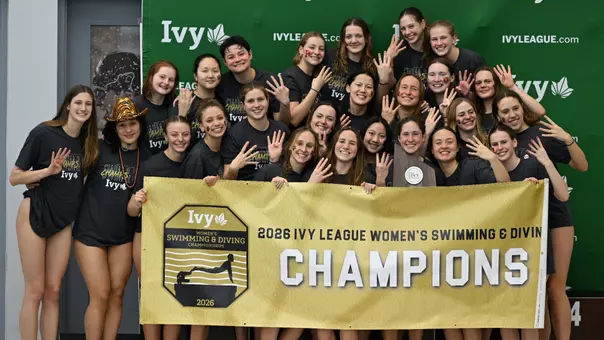 Women's Swimming & Diving with trophy and banner
