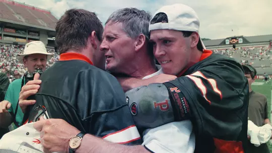 Trevor Tierney and Ryan Mollett congratulate Bill Tierney