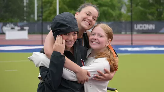 Princeton field hockey goalies in a hug