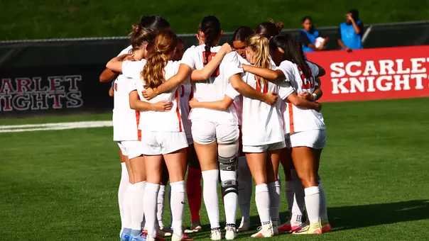 women's soccer huddle photo at rutgers