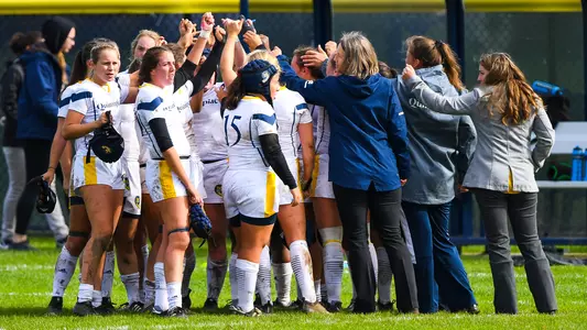 Women's Rugby Team Huddle vs. Brown