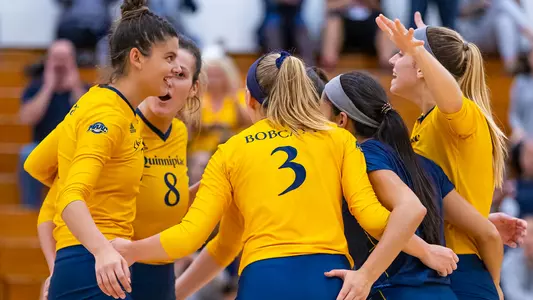Volleyball Team Celebrates Winning a Point Against Manhattan