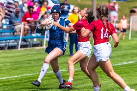 Maya le Rossignol stiff arms Harvard opponent