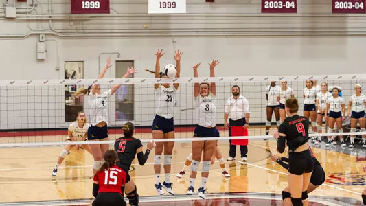 Quinnipiac Volleyball Goes up for a Block Against Rutgers