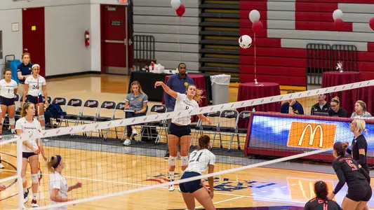 Maggie Baker Jumps to Attack the Ball Over the Net