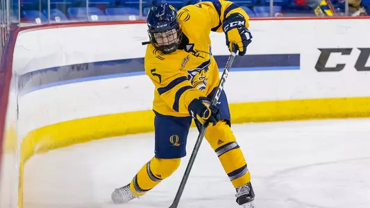 Kate Reilly sends a puck up the ice